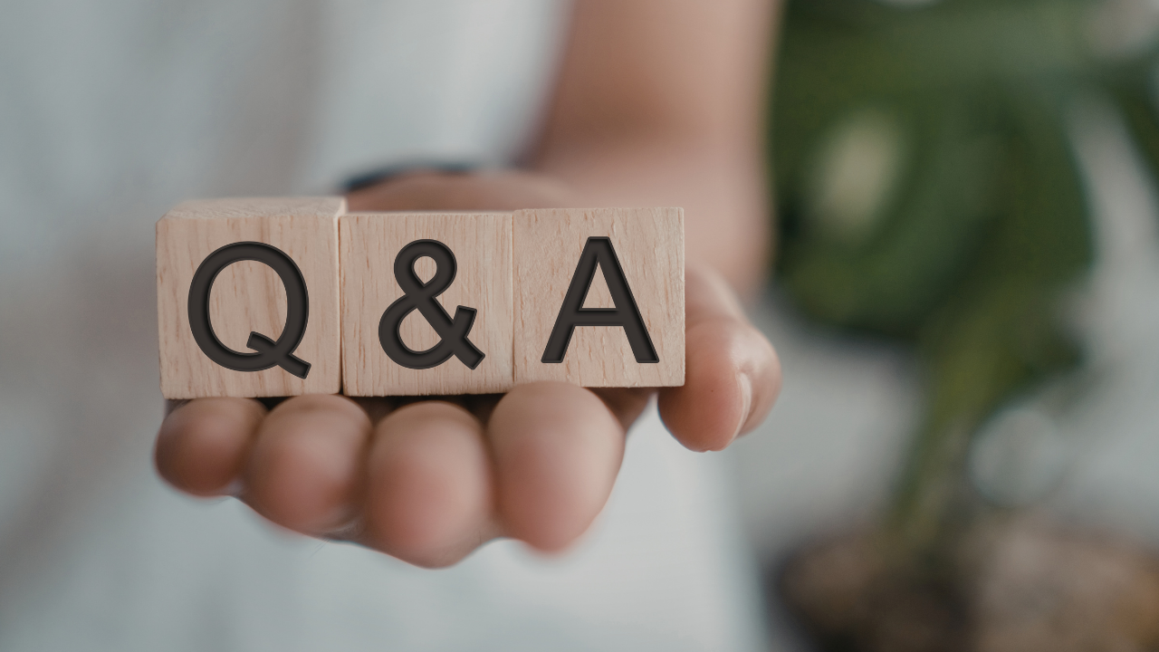 Image of hand holding blocks that says "Q&A"